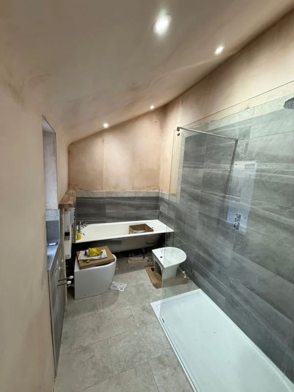 A modern bathroom in renovation with slate tiles.