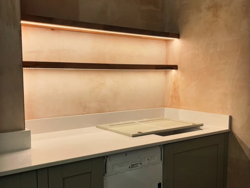 Two rows of kitchen shelf lighting.