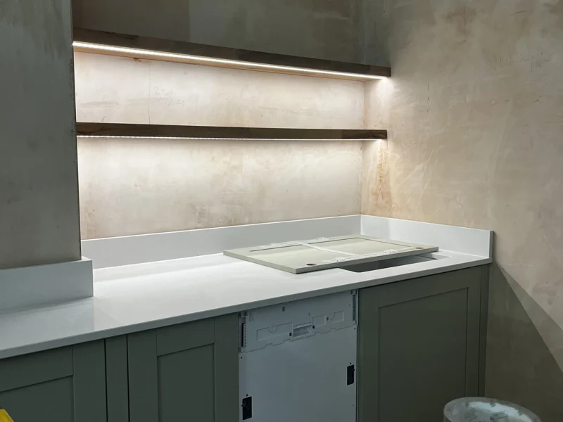 A kitchen refurbishment featuring a sink and countertop, showcasing a clean and organised cooking space.