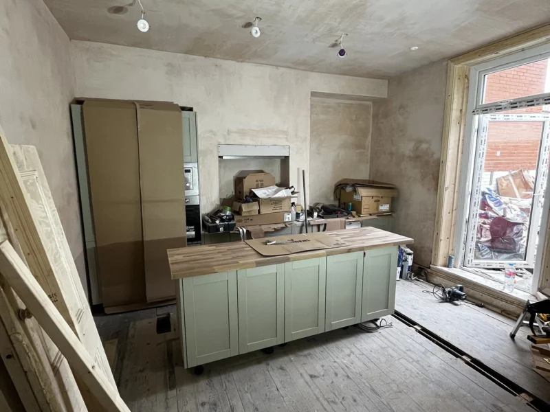 A spacious kitchen renovation featuring a large island, designed for functionality and style.